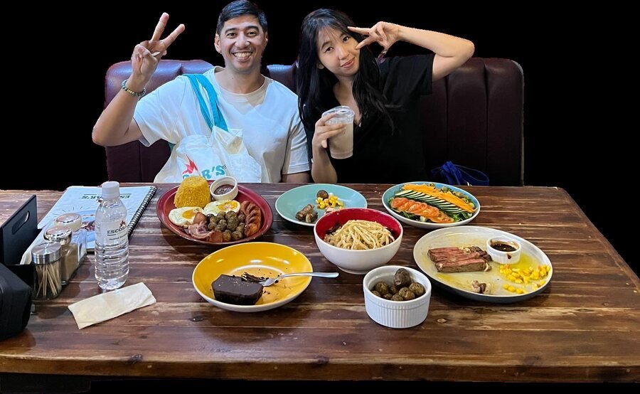 Patty with Dr. Deniel Escobar over a table at Escobar's Steakhouse